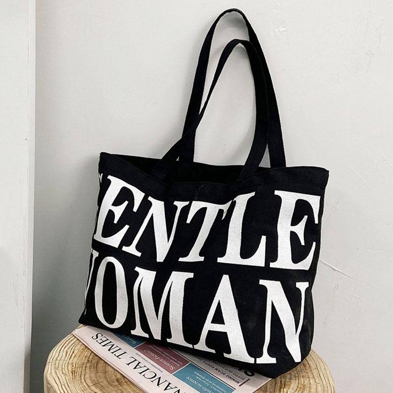 V562-B1055604060DBT-202505191448-00 Black Women Canvas Shoulder Tote Printed Letters - Image 1